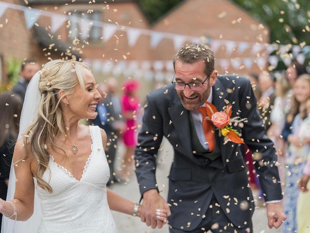 Jo and Chris experiencing the wedding confetti at Knockerdowns Weekend Wedding Venue